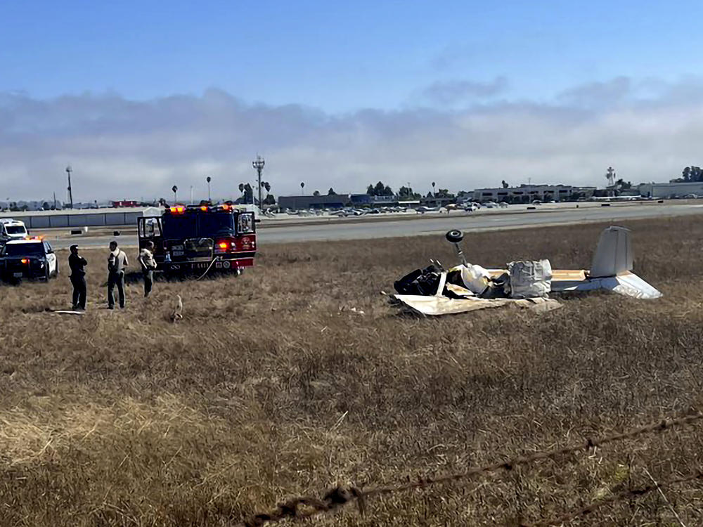 This photo provided by KION-TV shows multiple agencies responding to Watsonville Municipal Airport, in Santa Cruz County, Calif. after 2 planes attempting to land collided on Thursday, Aug. 18, 2022.