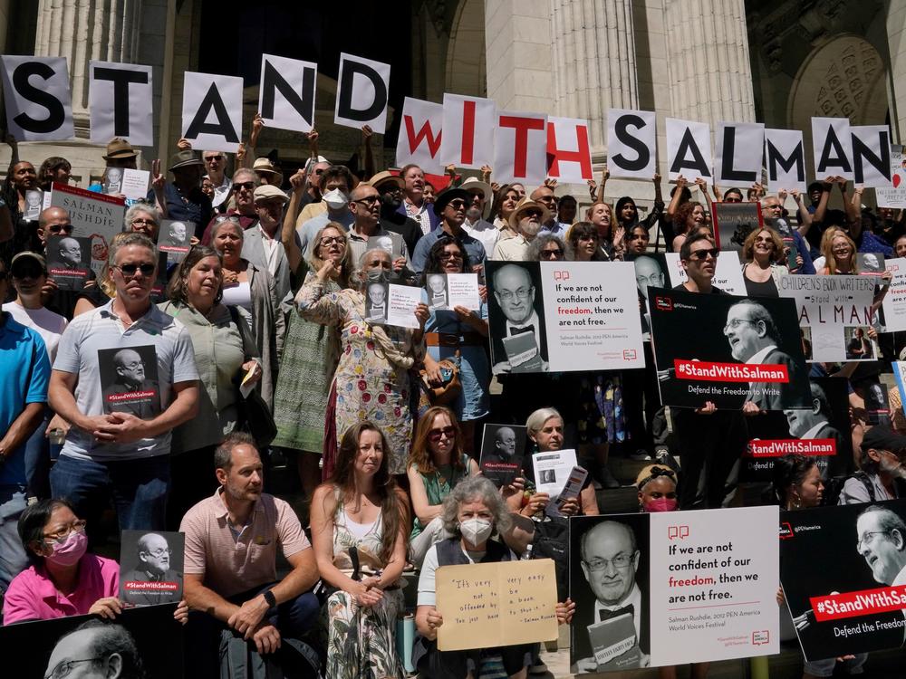 At a rally outside the New York Public Library, writers including Paul Auster and Gay Talese read passages from Salman Rushdie's work. His assailant has pleaded not guilty to attempted murder charges after being accused of stabbing Rushdie during a literary event at the Chautauqua Institution.