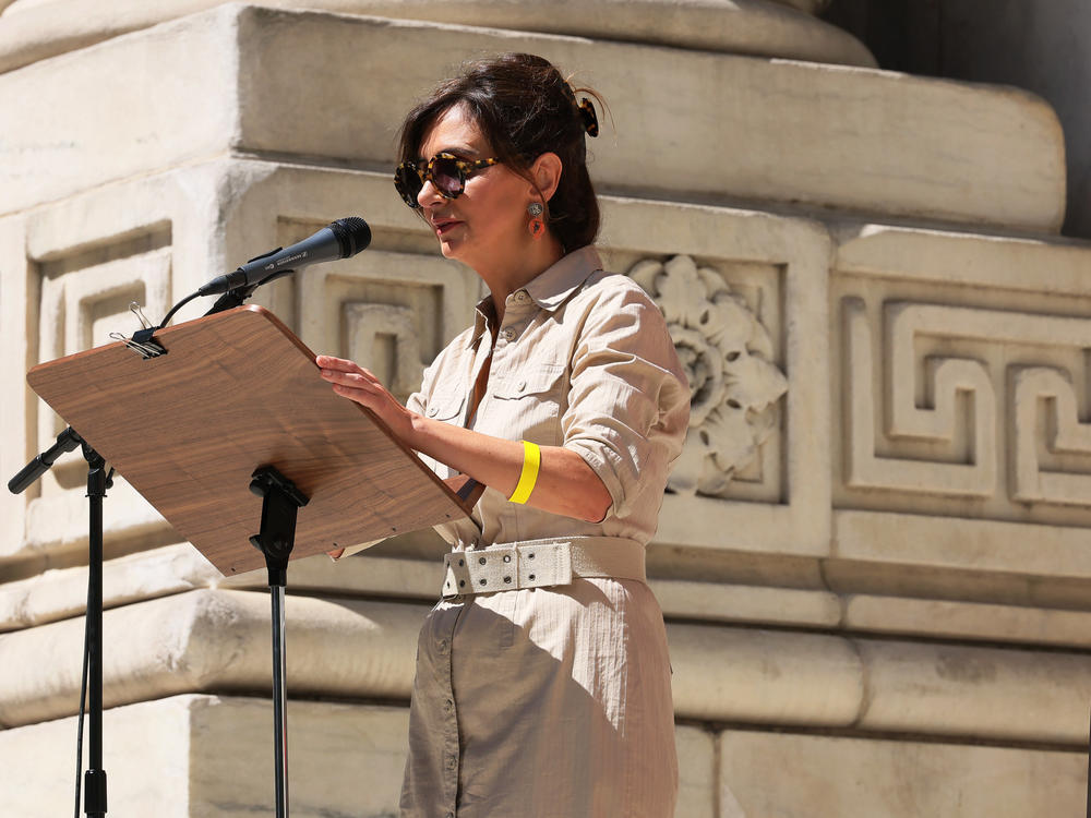 Iranian writer Roya Hakakian speaks as people gather at the steps of the New York Public Library to show support for Salman Rushdie on Friday.