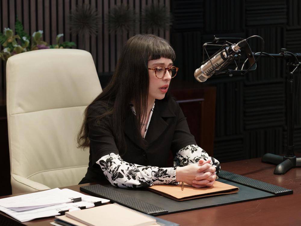 Poppy, played by Adina Verson, works as the beleaguered assistant to morally dubious podcaster Cinda Canning in the hit Hulu series <em>Only Murders In the Building</em>.