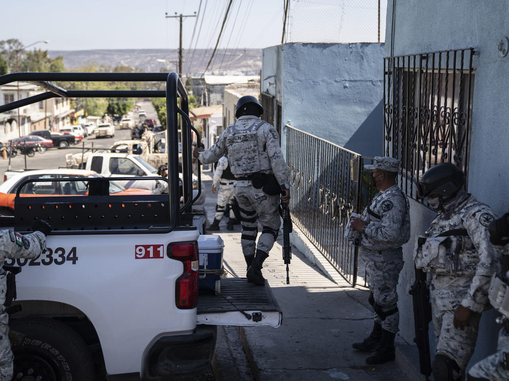 Members of the National Guard stand guard outside a military base in Tijuana.