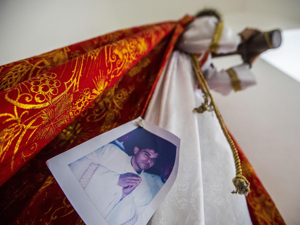 An image of Bishop Rolando Álvarez is pinned to a robe on a statue of Jesus Christ at the Cathedral in Matagalpa, Nicaragua, on Friday. Nicaraguan police on Friday raided Alvarez's residence, detaining him and several other priests in an escalation of tensions between the Catholic Church and the government of Daniel Oretga.
