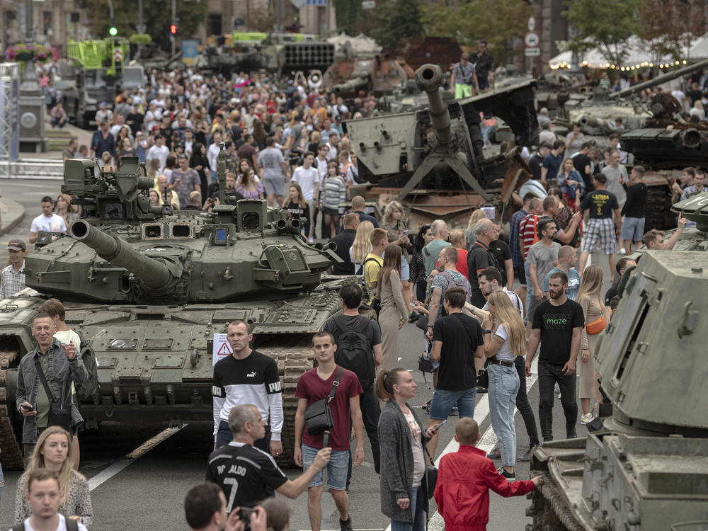 Ukrainians visit an avenue, where destroyed Russian military vehicles have been displayed in Kyiv, Ukraine.