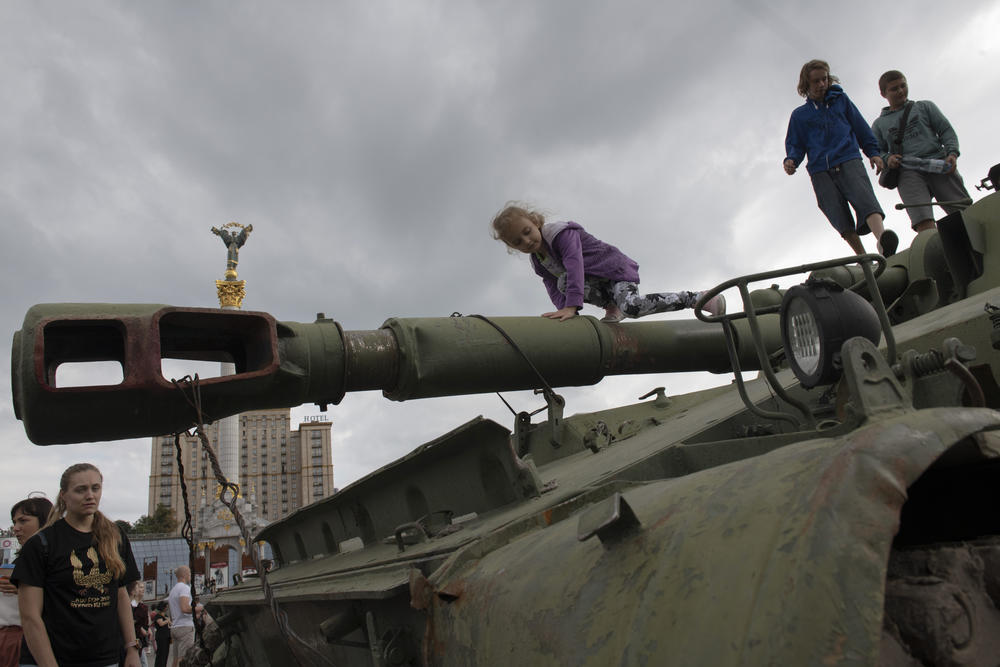 Children played on the cannon barrels, while friends took selfies in front of armored personnel carriers.