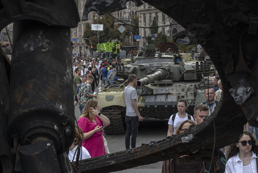Thousands of people walked along the way as more flat-bed trucks brought in their cargo.