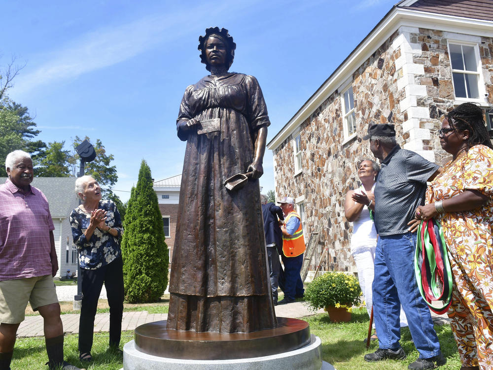 A monument of civil rights pioneer Elizabeth Freeman is unveiled in front of Sheffield's Old Parish Church in Sheffield, Mass., Sunday, Aug. 21, 2022.