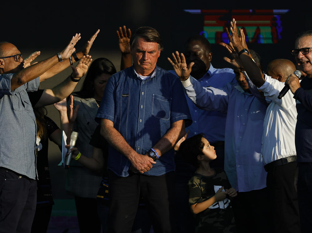 Brazilian President Jair Bolsonaro receives a blessing during a music festival organized by a local evangelic radio station on July 2, in Rio de Janeiro.