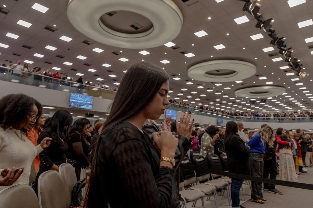 Evangelical churchgoers pray at the Assembleia de Deus Vitória em Cristo Church in the neighborhood of Penha, Rio de Janeiro, on Sunday. Having opened more than 18 new churches since 2020, the church also known by the initials ADVEC is one of the fastest growing evangelical churches in the country.