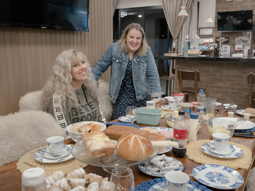 Andreia Burko Bley of Brazil (right) is of Ukrainian descent, shares a meal with her new friend, Ukrainian refugee Laryssa Moskvichova. The two women only met in June and have become close friends. Their families eat together often. Laryssa brings fresh baked Ukrainian goods. Andreia and her husband, Paulo, make sure the favorite foods of Laryssa's children are on the table.