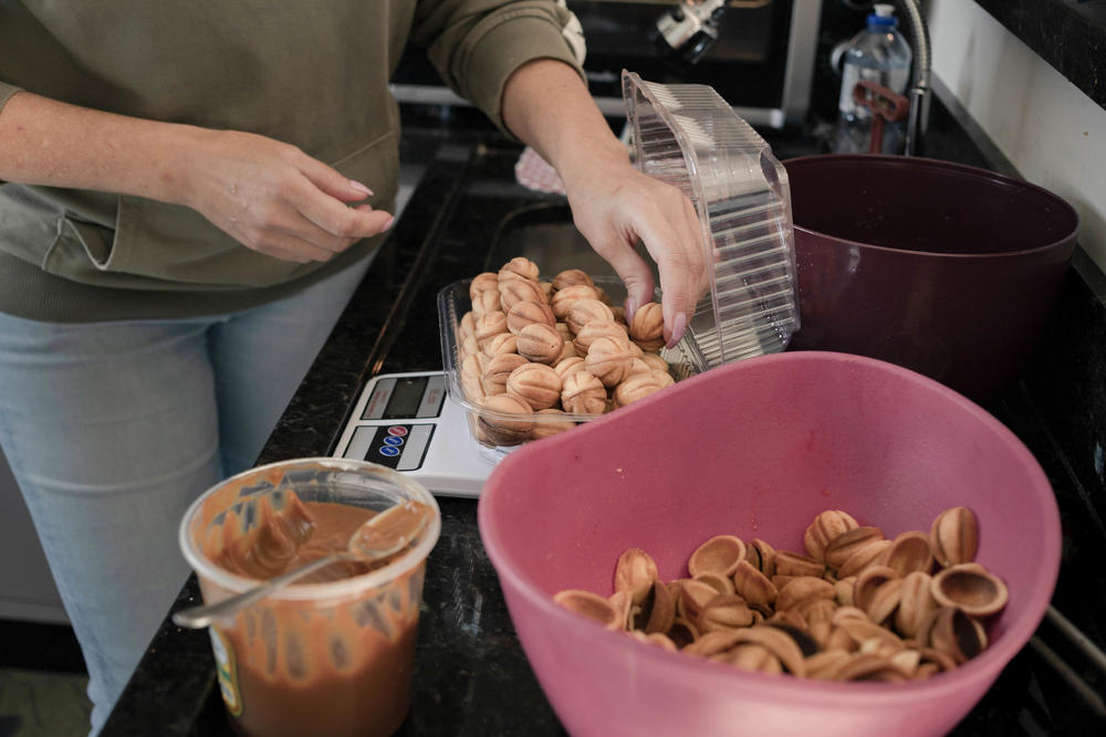 Laryssa Moskvichova bakes <em>oreshkis</em>, a Ukrainian cookie. She's getting a lot of orders for Ukrainian baked goods in her new home in Brazil. When she lived in Ukraine, Laryssa earned a living by selling toys and parrots and parakeets from her home.