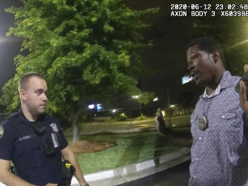 This screen grab taken from body camera video provided by the Atlanta Police Department shows Rayshard Brooks, right, as he speaks with Officer Garrett Rolfe, left, in the parking lot of a Wendy's restaurant in Atlanta on June 12, 2020.