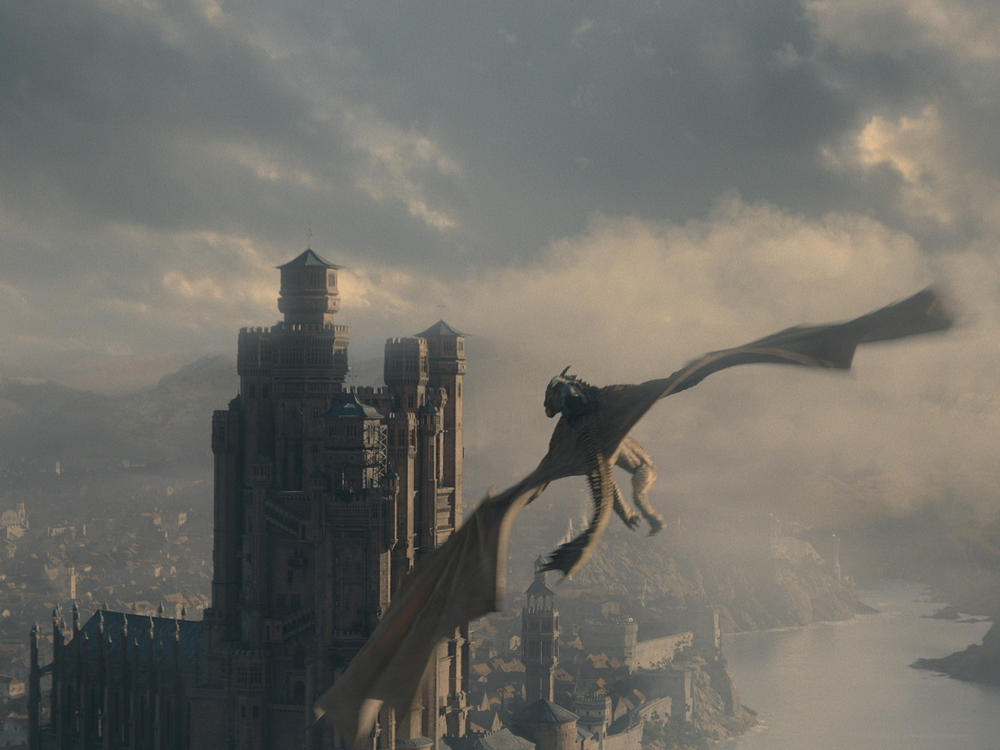 A dragon flies over King's Landing on <em>House of the Dragon</em>.