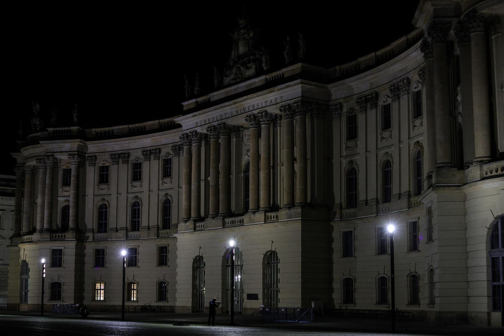 A violinist plays in front of the darkened Altes Palais (The Old Palace) with its facade illumination turned off on July 27 in Berlin. Berlin's Senate Department for the Environment ordered that the illumination of buildings and landmarks across the city be switched off in order to save energy.