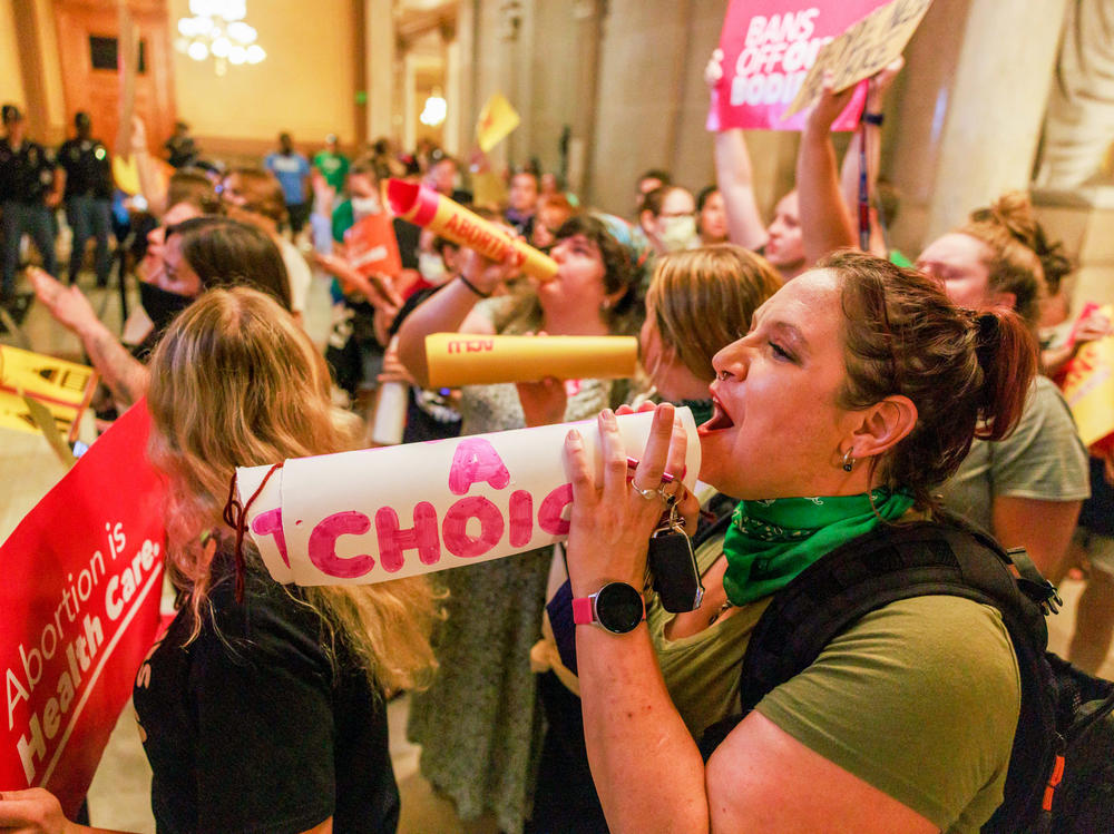 Abortion rights activists chant slogans as the Indiana Senate debates during a special session in Indianapolis before voting to ban abortions.