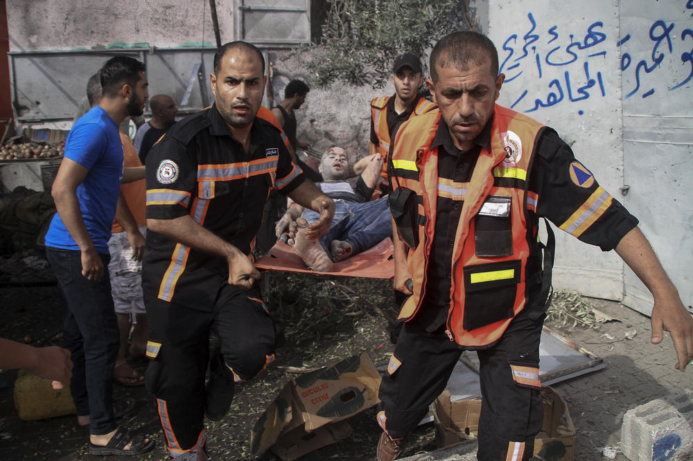 Members of Palestinian Civil Defense evacuate a wounded man following an explosion in Jebaliya refugee camp, Gaza, Aug. 7. Close to a third of Palestinians who died in the latest outbreak of violence may have been killed by errant rockets fired by the Palestinian side, according to an Israeli military assessment that appears consistent with independent reporting by The Associated Press.