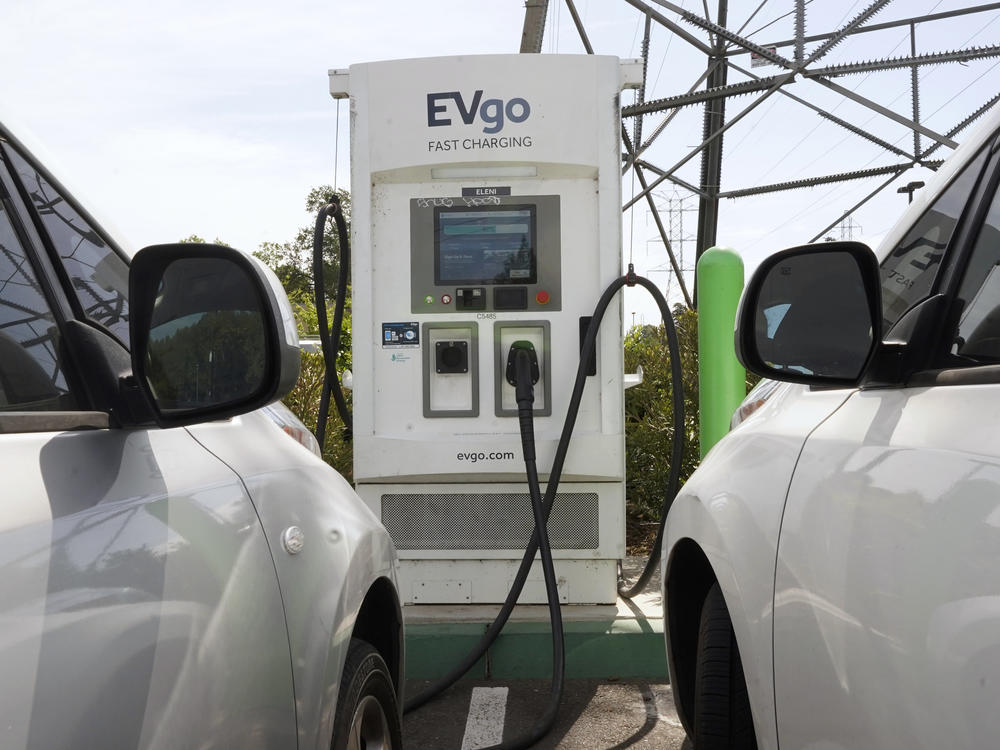 Electric cars are parked at a charging station in Sacramento, Calif.