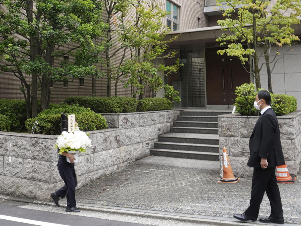 Flowers arrive at the residence of former Prime Minister Shinzo Abe in Tokyo Thursday, Aug. 25, 2022. Abe's family paid tribute to him in a private ritual Buddhist ritual Thursday marking the 49th day of his assassination.