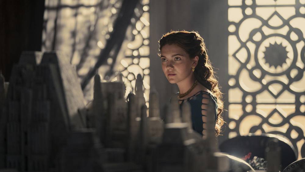 Alicent (Emily Carey) feigns interest while getting mansplained about Old Valyrian infrastructure projects.