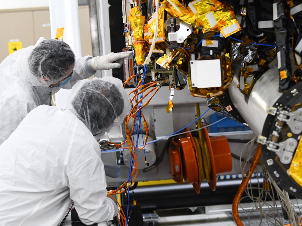 Workers prepare the Psyche spacecraft inside a clean room at NASA's Jet Propulsion Laboratory in Pasadena, Calif., in April. After a delay, Psyche, which will enter orbit in space around an asteroid, is expected to launch next year.