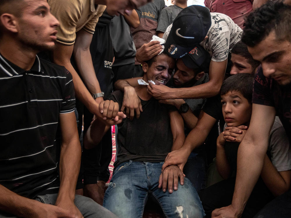 Relatives of Lian al-Shaer, a 10-year-old Palestinian girl, mourn during her funeral ceremony in Khan Yunis in the southern Gaza Strip on Aug. 11. Lian died of injuries sustained during the violence between Israel and Islamic Jihad.