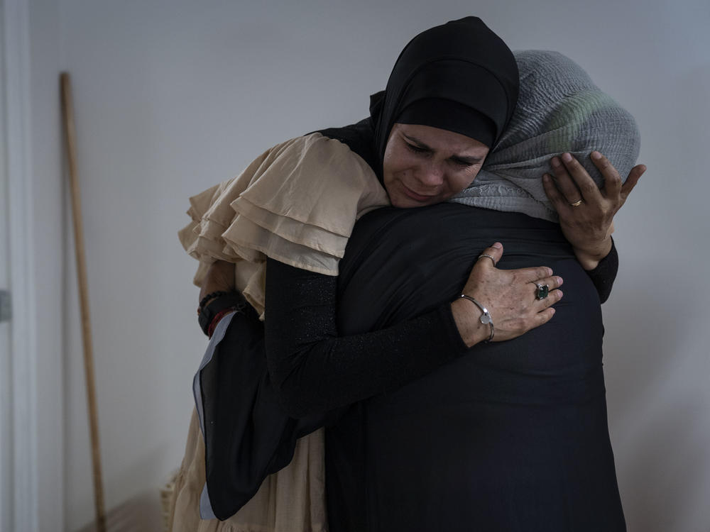 García greets a woman before Friday prayer.