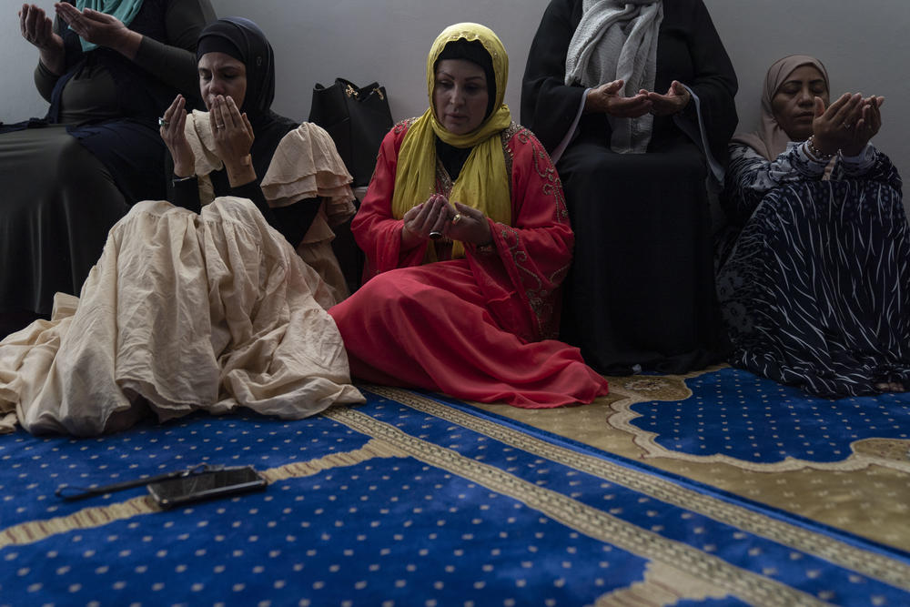 García, left, attends Friday prayer at the mosque.