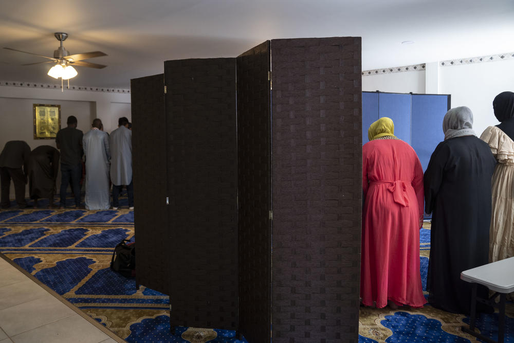 People attend Friday prayer at the mosque in the Assabil shelter.