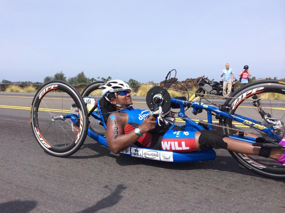 Minda Dentler handcycling at mile 32 of The Kona Ironman in Hawaii, 2013. She's the first female wheelchair athlete to complete the Ironman World Championship. When she was an infant, her legs were paralyzed by polio. 