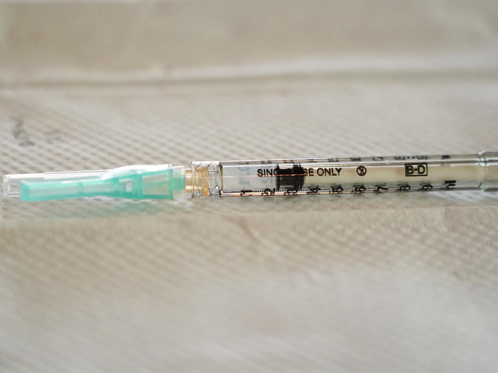 A single-use syringe awaits to be filled with the Moderna COVID-19 vaccine. Moderna has sued rival drugmakers for patent infringement.