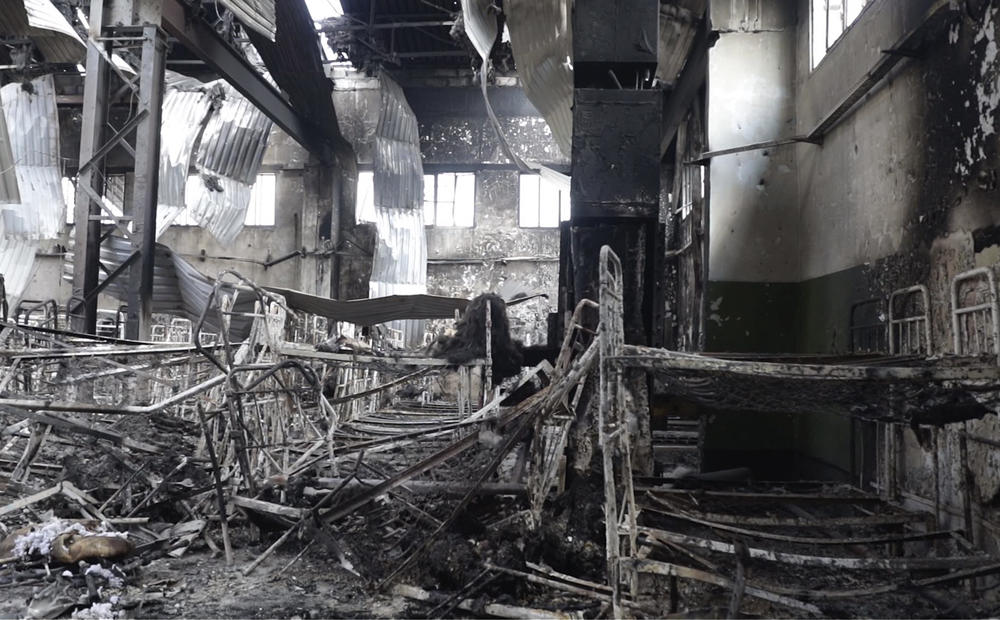 This photo taken from video shows a view of a destroyed barrack at a prison in Olenivka, in an area controlled by Russian-backed forces in eastern Ukraine, on July 29. Ukrainian officials say they are struggling to establish the truth surrounding the explosion in a prison that killed dozens of Ukrainian prisoners of war captured by the Russians following the fall of Mariupol.