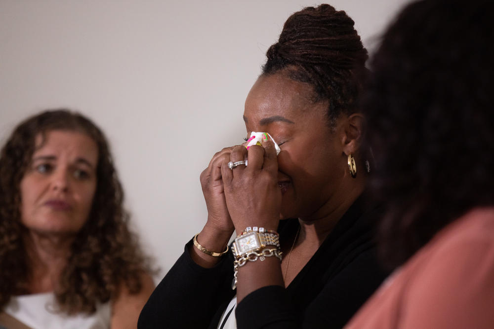 Atlanta resident Alana Leverette gets emotional as she joins a group of six women during a discussion about their experience with miscarraiges.
