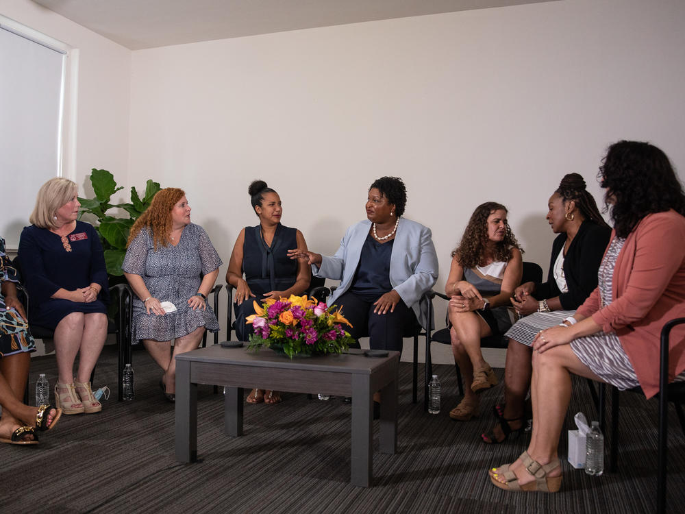 Georgia Democratic gubernatorial candidate Stacey Abrams joins a group of women as they discuss their personal stories of miscarraige at her campaign headquarters in Decatur, Ga. on Aug. 3.