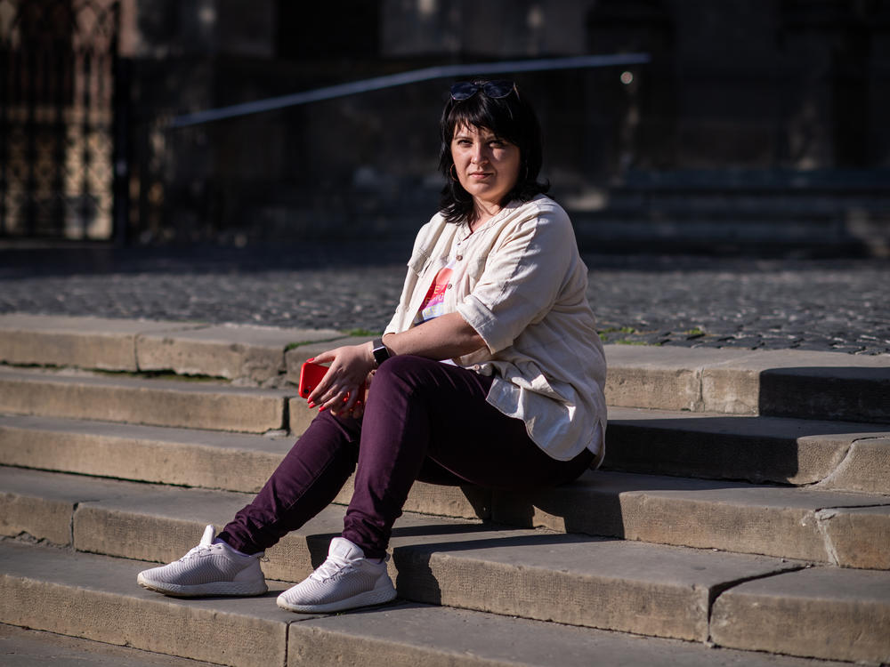 Olha Kerod, the wife of a Ukrainian soldier who was captured by Russian forces in Mariupol, poses in front of the Church of Sts. Olha and Elizabeth, where she often prays, in Lviv, Ukraine, on July 18. 