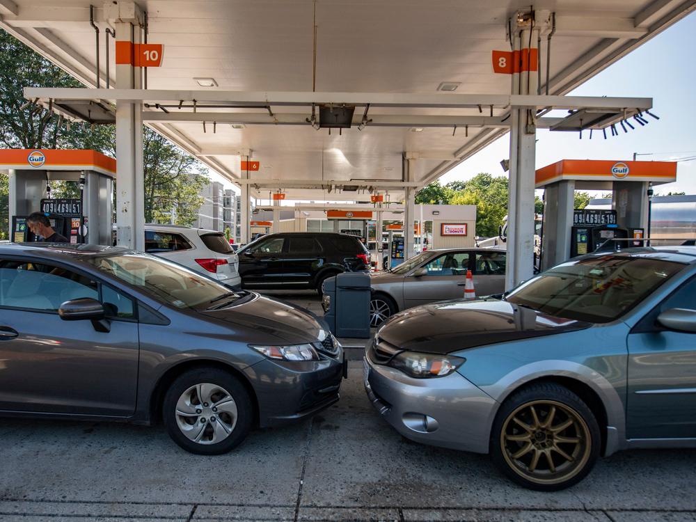 Cars sit at gas pumps at a Gulf gas station in Lynnfield, Mass., on July 19. California's action to ban sales of new gas-powered vehicles could prove seminal in the country's transition to zero-emission cars.
