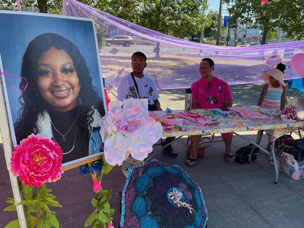 Memorial set up by friends and family of Jashawna Hollingsworth, who was shot and killed outside a shopping mall in south Seattle in late 2021. The slaying remains unsolved.