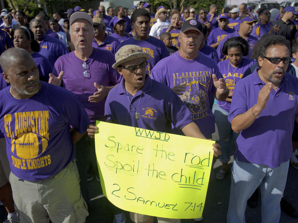 In this March 26, 2011 file photo, supporters of St. Augustine High School, including Byron Bernard, class of 1980, center, with 