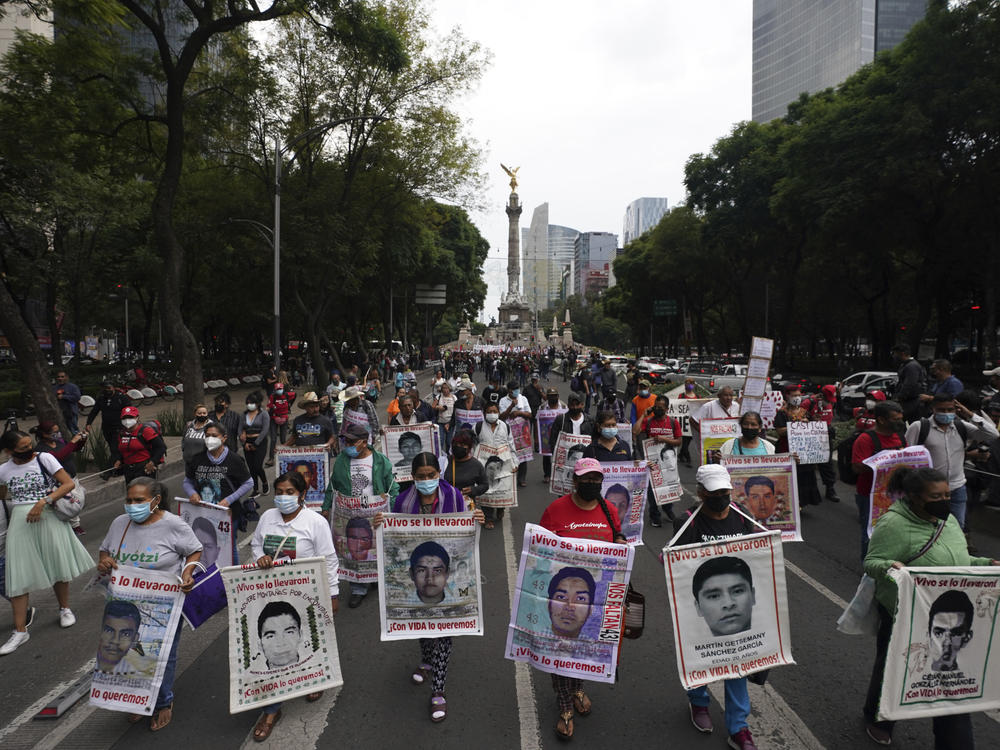 Family members and friends march seeking justice for the missing 43 Ayotzinapa students in Mexico City on Friday.