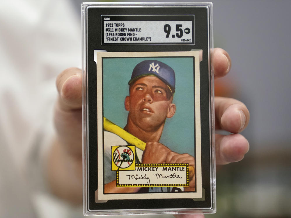 A Mickey Mantle baseball card is displayed at Heritage Auctions in Dallas, earlier this summer. A mint condition Mantle card has sold for $12.6 million, blasting into the record books.