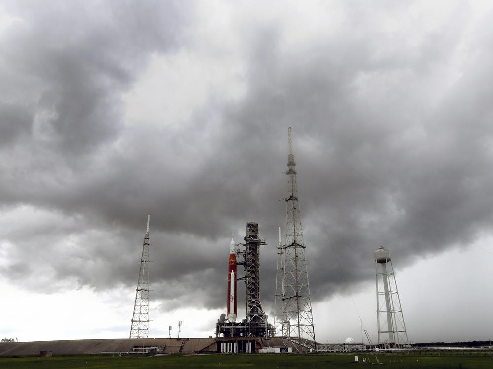 Storm clouds roll in over the NASA moon rocket as it stands ready for launch on Pad 39B for the Artemis 1 mission at the Kennedy Space Center, on Saturday in Cape Canaveral, Fla.