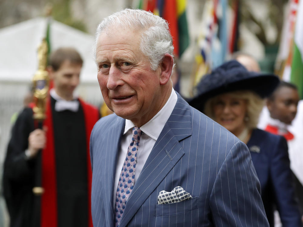 In this Monday, March 9, 2020, photo, Britain's Prince Charles and Camilla the Duchess of Cornwall, in the background, leave after attending the annual Commonwealth Day service at Westminster Abbey in London. The Prince of Wales has edited an edition of British African-Caribbean newspaper 