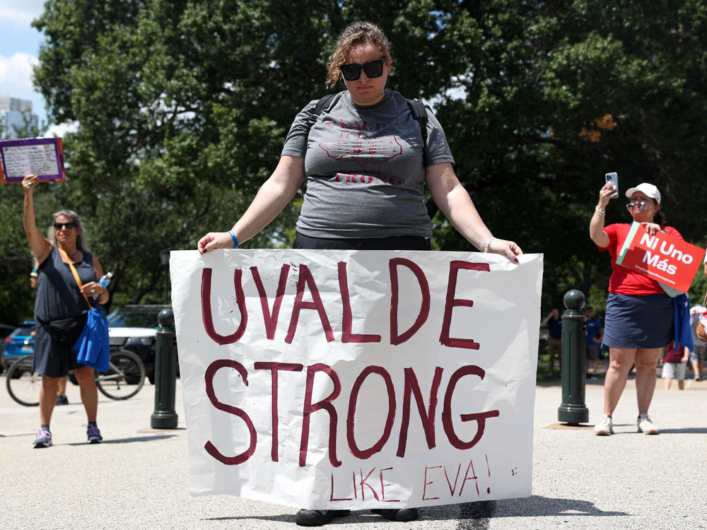 Sophia Zamarripa holding a sign saying, 