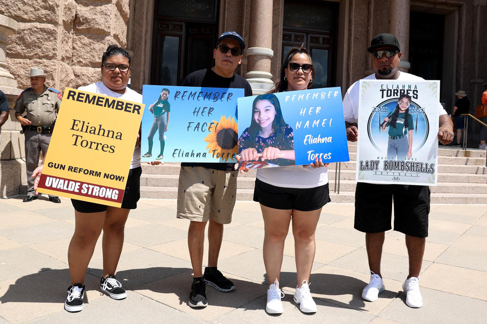 Parents and cousin of Eliahna Torres posing for a photo after the rally to demand for age increase in buying an AR-15.