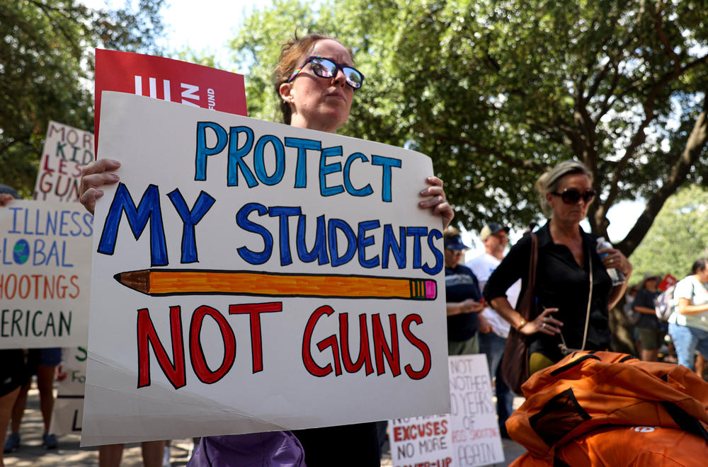 Protestor holding a sign during the rally in the Texas Capitol to demand age increase for AR-15 sales.