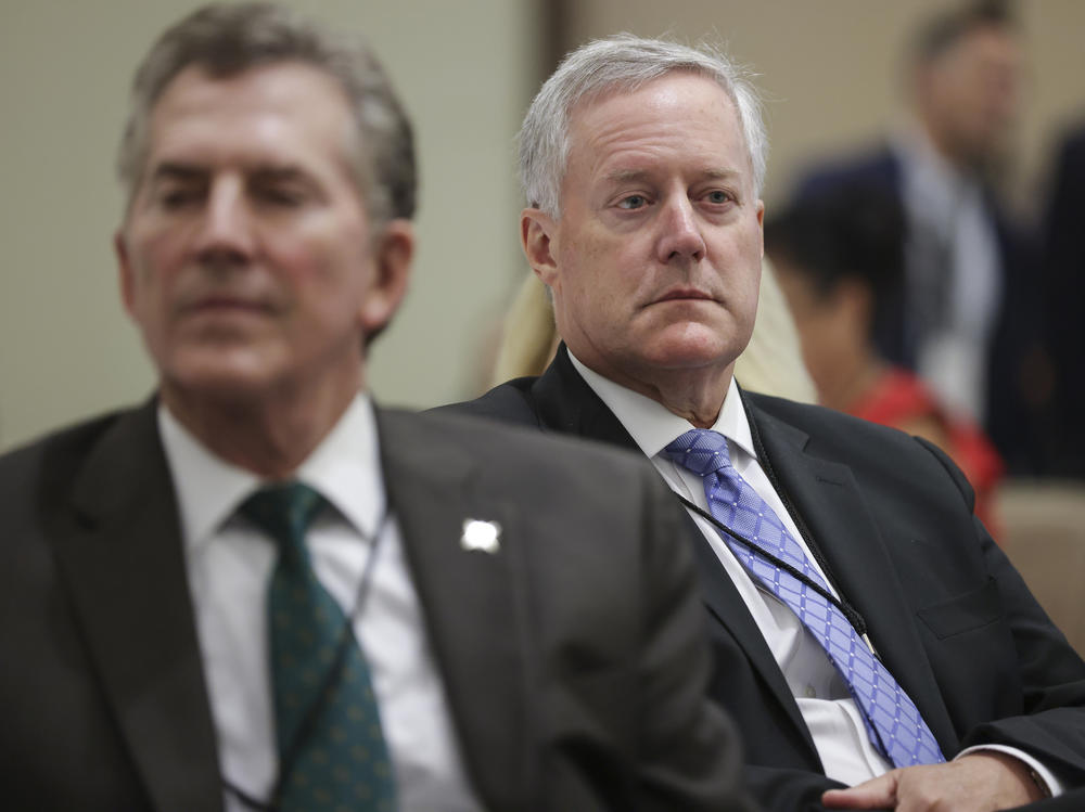 Former White House chief of staff Mark Meadows, right, and former Republican Sen. Jim DeMint, left, attend a summit organized by the America First Policy Institute on July 25. Meadows and DeMint have both been involved with the Conservative Partnership Institute, a nonprofit raising concerns among tax experts.
