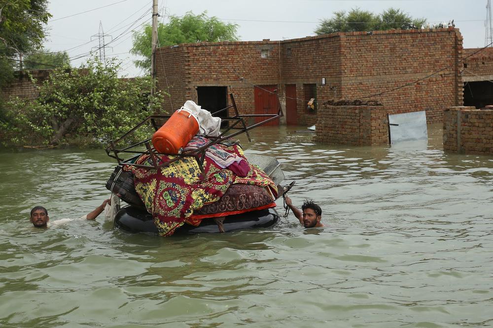 Residents move their belongings from their submerged houses after heavy monsoon rainfall in the Rajanpur district of Pakistan's Punjab province on Aug. 24.
