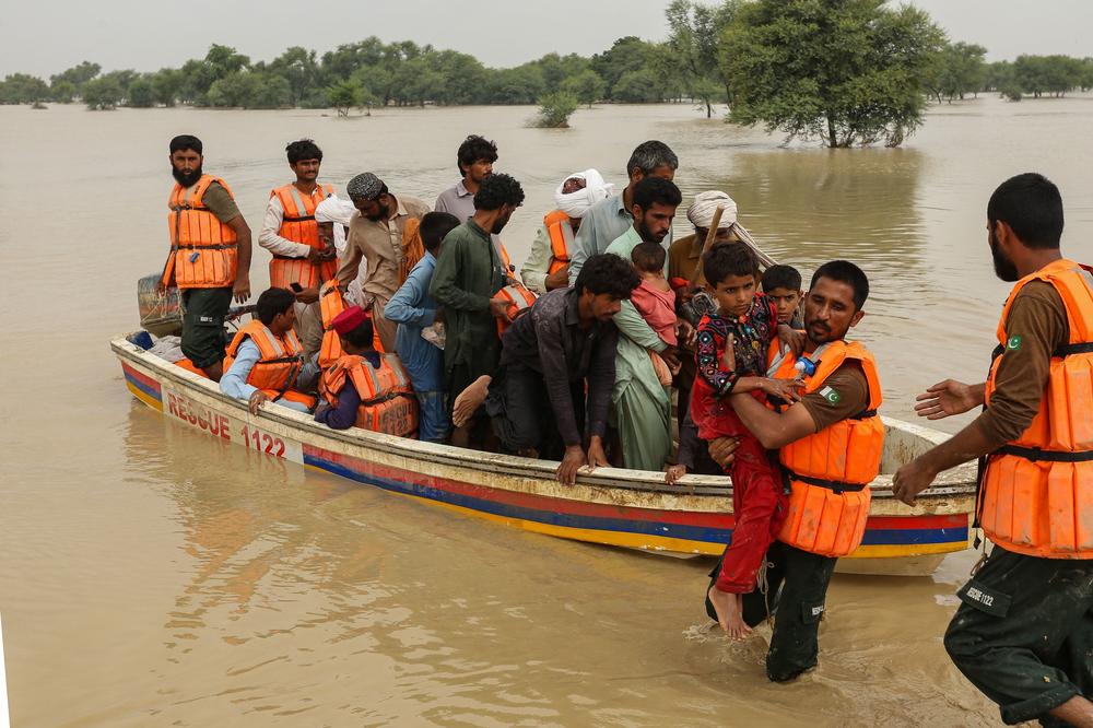 Rescue workers help evacuate people from homes hit by floods in Punjab's Rajanpur district, on Aug. 27.