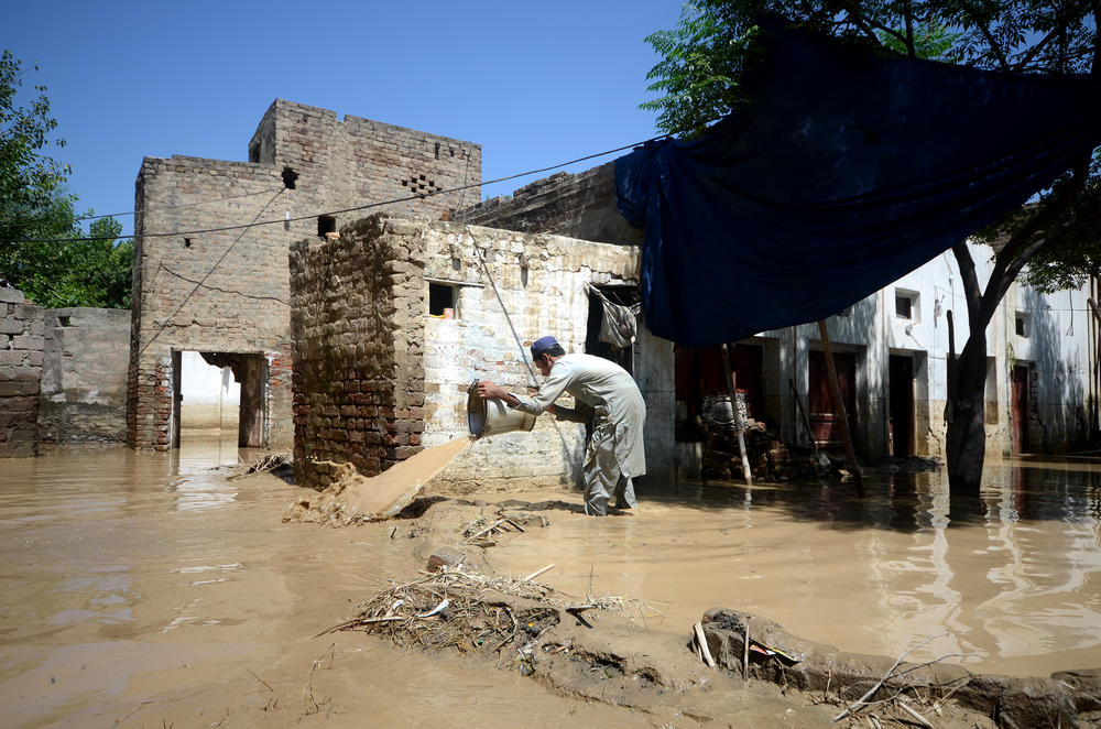 A man pours out water in a flooded area in Charsadda, Khyber Pakhtunkhwa province, Pakistan on Aug. 28.