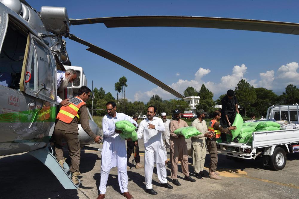 Security personnel load relief food bags into a government helicopter for people affected by floods in Saidu Sharif, in the Swat Valley, on Aug. 30. On Tuesday, the U.N. launched an appeal with the Pakistani government to raise $160 million in emergency aid.
