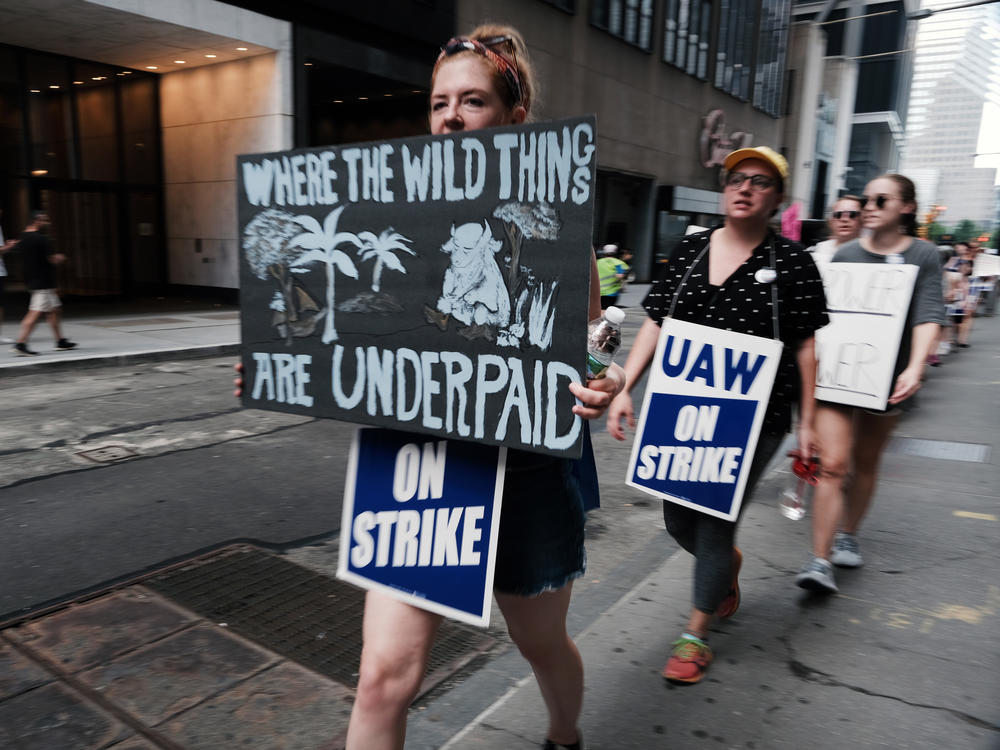 Employees of HarperCollins Publisher participate in a one-day strike outside the publishing houses offices in Manhattan on July 20, 2022 in New York City.