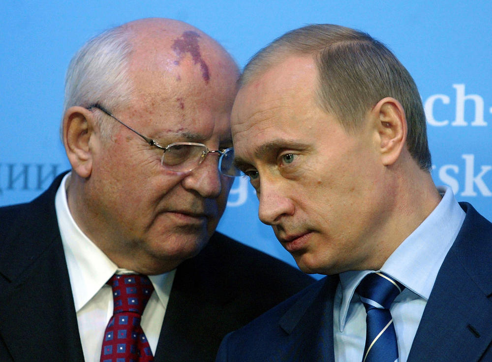 Russian President Vladimir Putin (R) talks to former Soviet President Mikhail Gorbachev (L) before a press conference of German Chancellor Gerhard Schroeder and Putin at Gottorf castle in Schleswig on Dec. 21 2004.